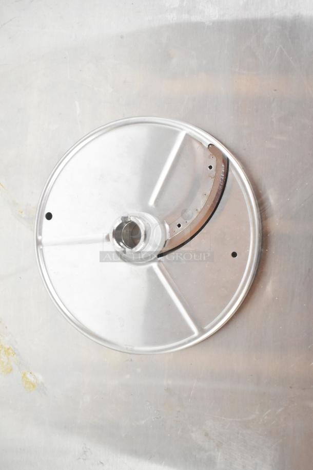 Stainless steel grating blade with circular design for pelican head use, part of a 7-piece kitchen attachment set.