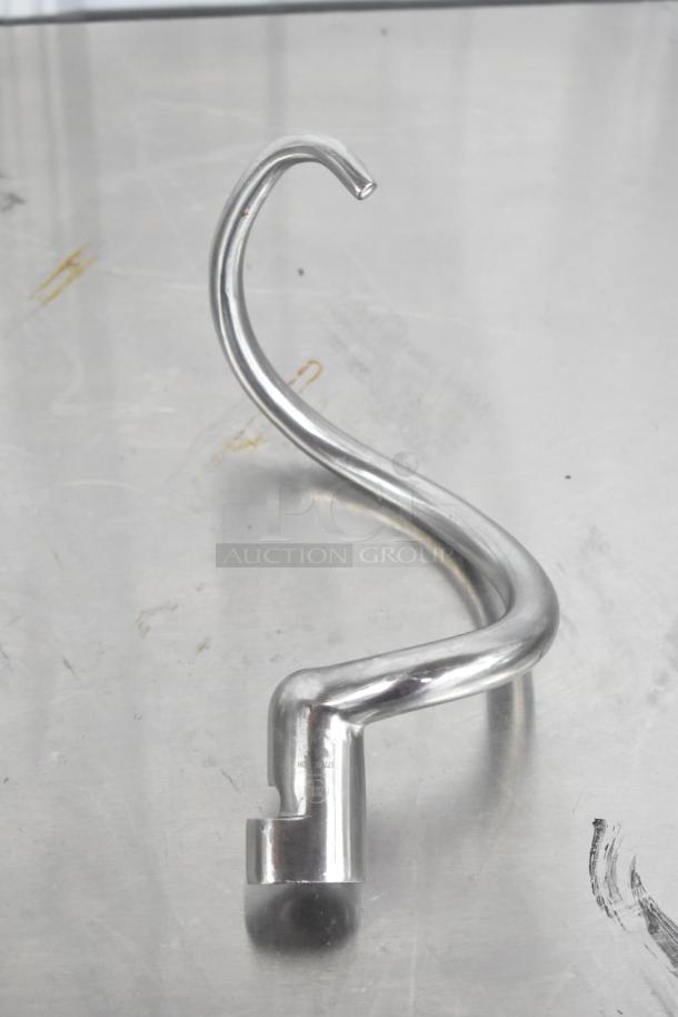 Stainless steel dough hook attachment for mixer, in good condition, with visible markings indicating compatibility.