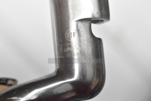 Close-up of a metal attachment with "NSF" marking and item number 177MBXA211, indicating high quality and safety standards.