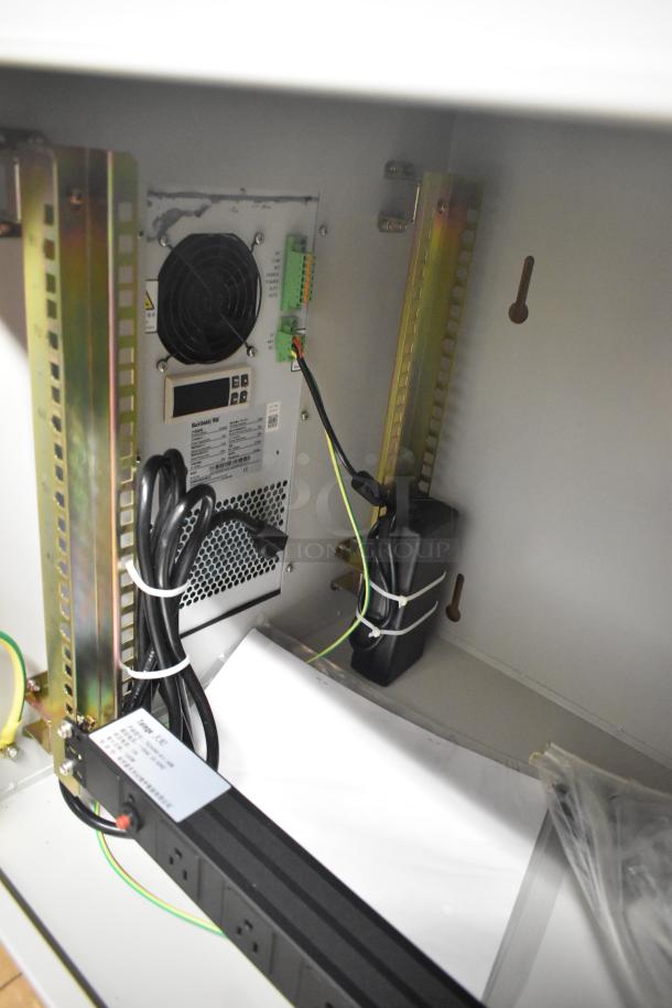 BlackShields DC0300 white metal technology cabinet with air conditioning, interior view showing fan, wiring, and labels.