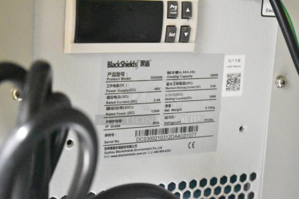 BlackShields DC0300 white metal air-conditioned technology cabinet with visible control panel and product specifications label.
