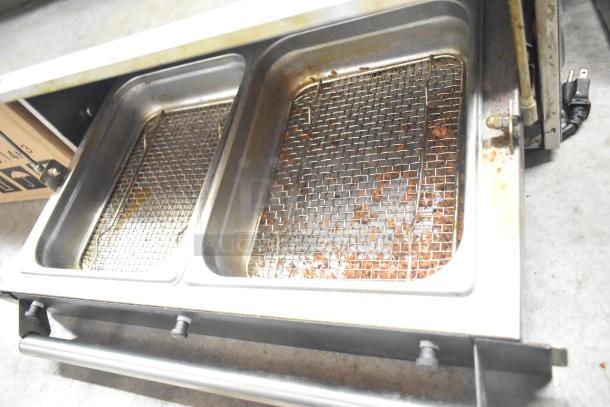 Hatco Commercial Countertop Heated Holding Merchandiser with two stainless pans and wire racks, showing signs of use and wear.