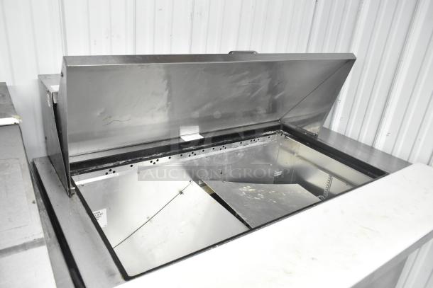 2016 True TSSU-48-18MB-HC prep table, stainless steel, open top, clean interior, on commercial casters, 115V, 1 phase.