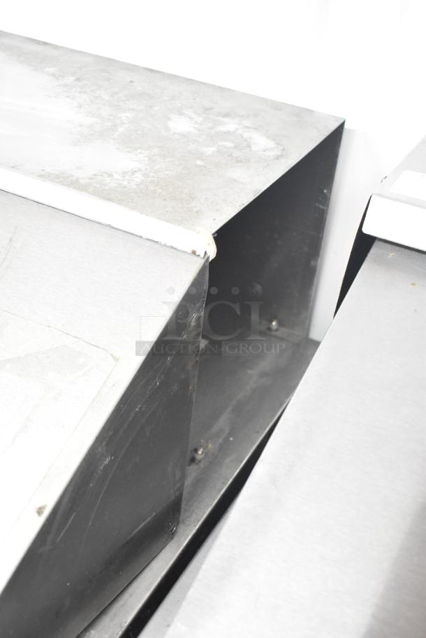 Beverage Air SPE48-18M-HMP sandwich prep table with stainless exterior, commercial casters. 115V, 1 phase. Shows signs of use.