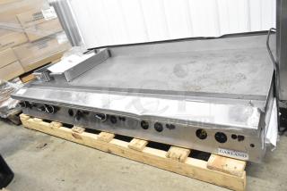 Garland commercial countertop gas-powered flat top griddle. Stainless steel, signs of use, controls front-facing, Garland label.
