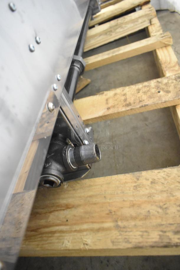 Garland Commercial Gas Flat Top Griddle, stainless steel, mounted on a wooden pallet, visible gas connection, new condition.