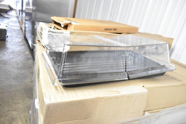 72 scratch and dent boxes with Cambro RD1220CWH135 clear hinged display covers, Cambro DT1220CW110 black trays.