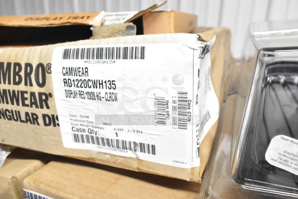 72 brand new boxes of Cambro items, including RD1220CWH135 clear hinged display covers and DT1220CW110 black trays. Boxes show label details.