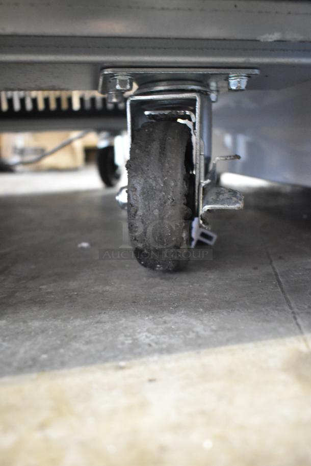 KoolMore RIR-2D-SS cooler caster; black, slightly worn. Part of commercial 2-door reach-in cooler, 115V, 1 phase.