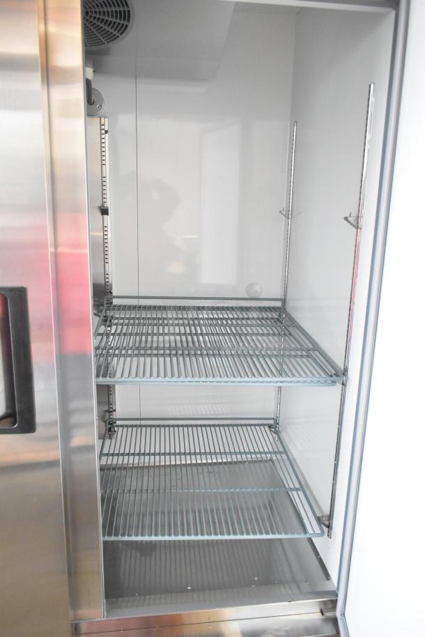 Brand new Avantco 178A49RHC commercial 2-door reach-in cooler, 115V, showing interior shelves. Minor scratches and dents.