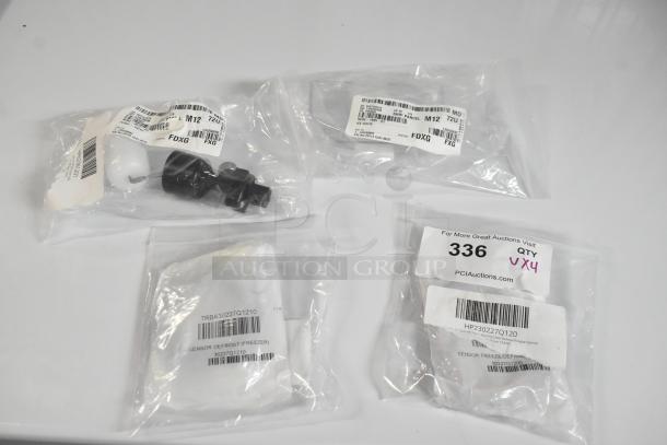 Four new Turbo Air and Scotsman refrigeration parts, including defrost sensors and chute flap, in original packaging with labels.