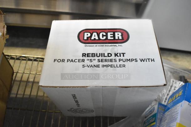 Box labeled "Pacer Rebuild Kit for 'S' Series Pumps" with 5-vane impeller, alongside boxes of Aleve medication and other items.