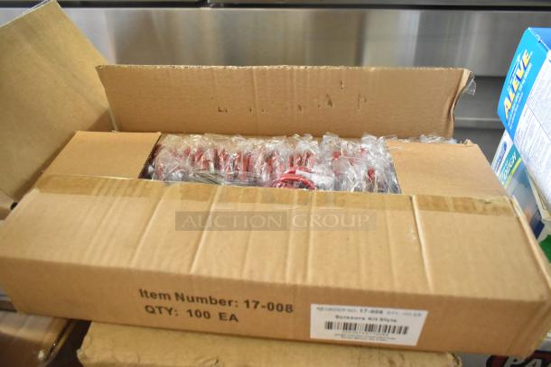 Cardboard box containing scratch and dent items like tweezers, medicine, bandages, eye pads. Item number 17-008, qty 100 EA.