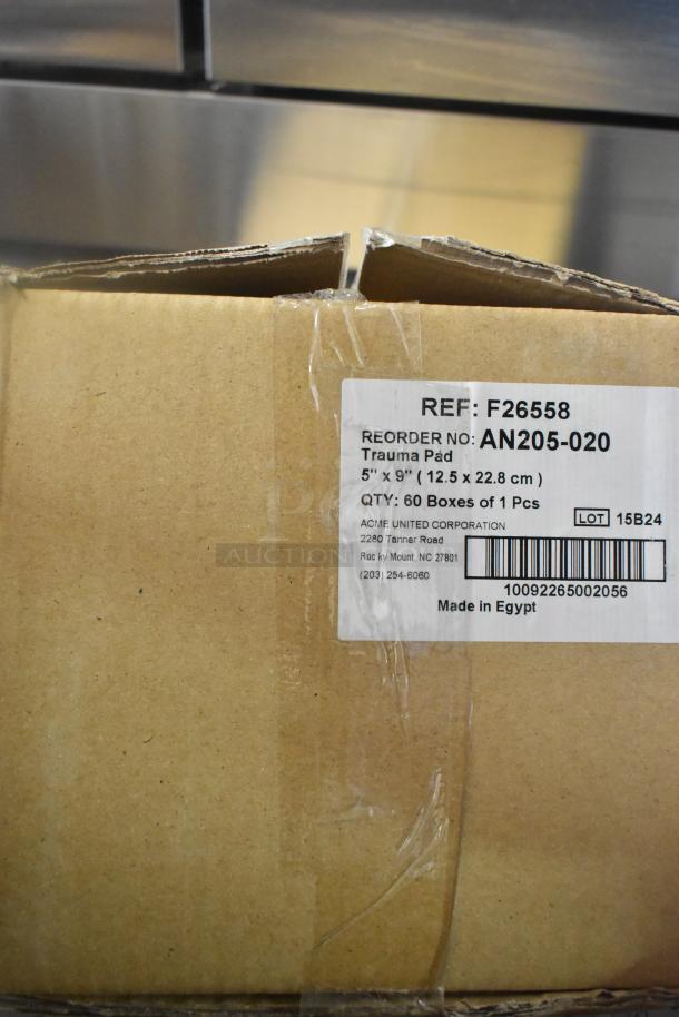 Cardboard box with label for trauma pads, 5"x9", REF: F26558. Contains 60 boxes. Made in Egypt. Minor wear on packaging.