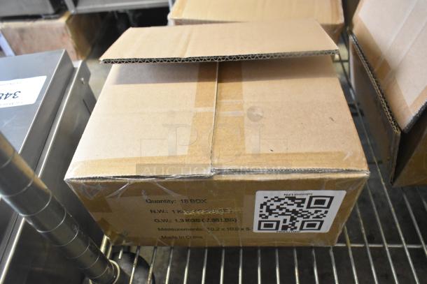Cardboard box labeled with quantity details and a QR code, containing 11 new scratch and dent items.