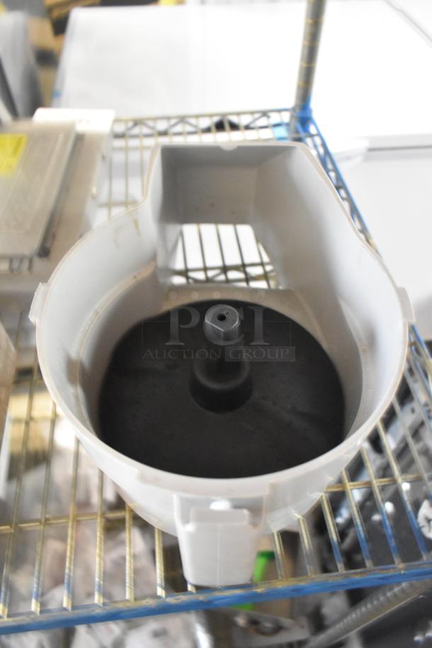 Brand new gray poly continuous feed head for food processor, slight scratches and dents visible, durable design.