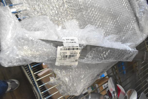 Brand new Vulcan grease strip and element, shown in bubble wrap with visible labels indicating model numbers for auction.
