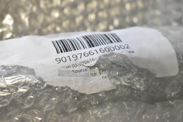 Close-up of a barcode label on bubble-wrapped Vulcan strip grease, model 00-976616-00002.