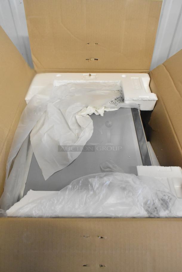 Panasonic NE-1054F Commercial Microwave Oven in its original box with packaging materials, indicating new condition.