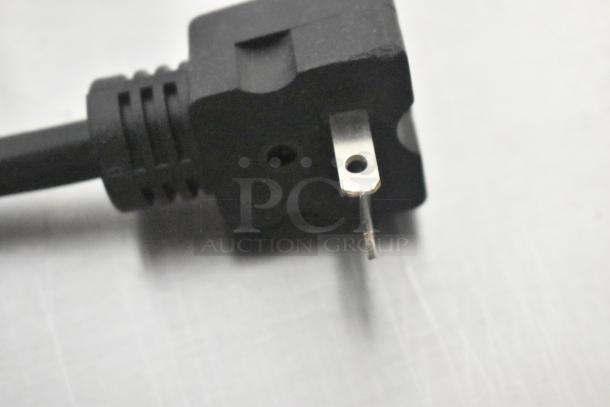 Close-up of a standard black power plug compatible with the Avantco 1777FW200D food warmer, showing prongs and cord detail.