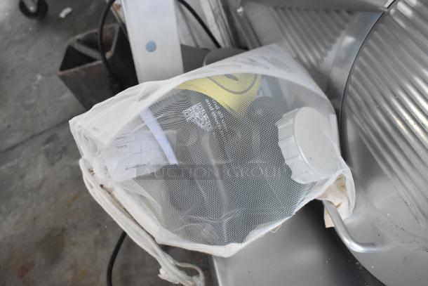 2025 Bizerba GSP H Commercial Meat Slicer, 120V, 1 Phase, in good condition. Mesh cover with documentation visible.