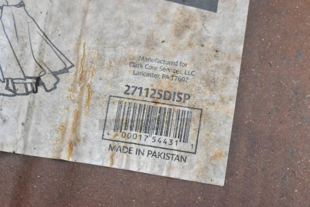 Close-up of worn product label showing barcode, numbers, and "Made in Pakistan." Shows Clark Core Services info.