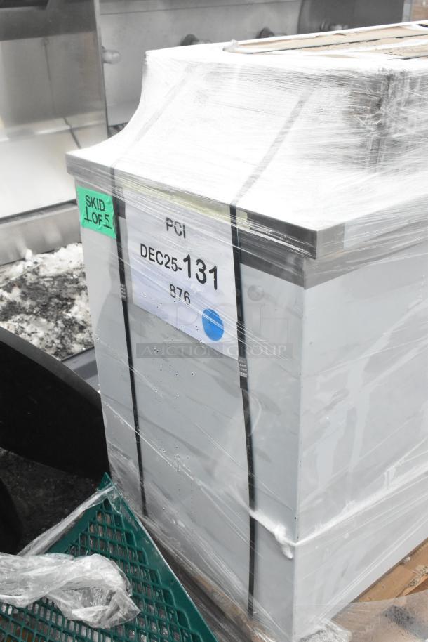 Brand new table and wire shelves, wrapped for protection. Visible label: "PCI, DEC25-131." Scratch and dent condition.