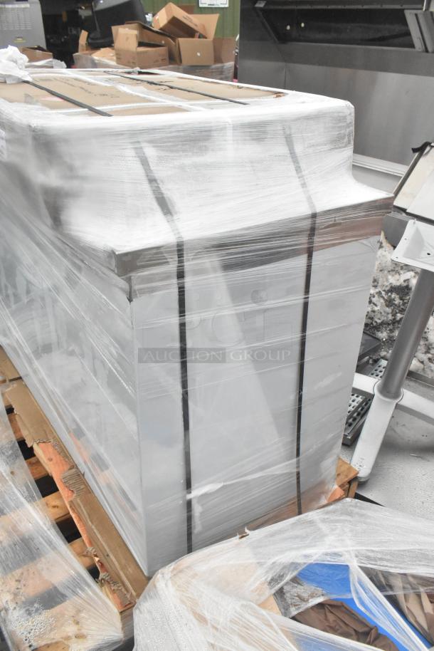 Plastic-wrapped, scratch and dent table and wire shelves, brand new, on pallets, ready for auction.