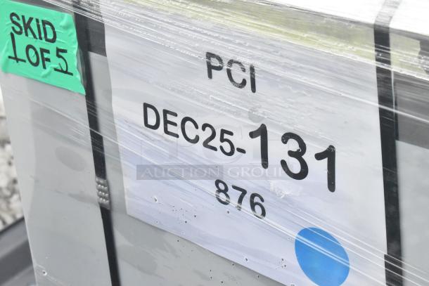 Plastic-wrapped package labeled "PCI DEC25-131 876," marked "Skid 1 of 5," containing new scratch and dent items.