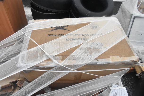 Cardboard box labeled "Regency Stainless Steel Mop Sink 24x24x13" wrapped in plastic, part of scratch and dent auction items.