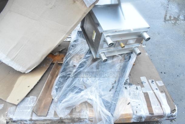 4 brand new scratch and dent items, including an ice bin and shelves, partially unpacked with protective materials visible.