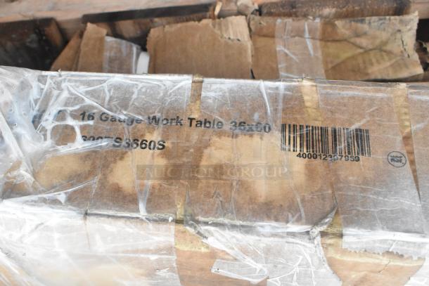 Cardboard box labeled "16 Gauge Work Table 36x60." Visible plastic wrapping and barcode 400012367959. New condition.