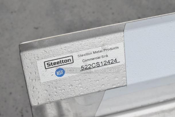 Steeltone commercial sink, model 522CS12424, brand new, NSF certified, with visible water droplets and label.