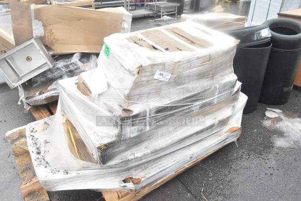 Pallet with scratch and dent equipment including an equipment stand, shelf kit, and work table, wrapped in plastic wrap.