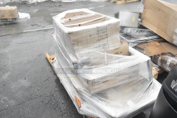 Pallet with wrapped boxes, labeled for a shelf kit, equipment stand, work table; in scratch and dent condition.