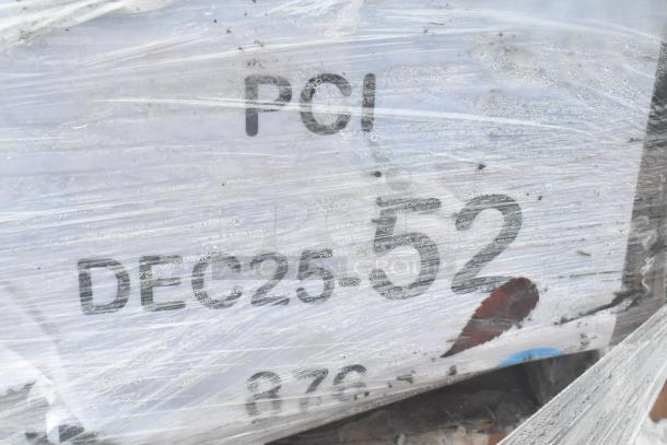 Plastic-wrapped pallet with visible markings "PO1" and "DEC25-52" indicating shipment or inventory details.
