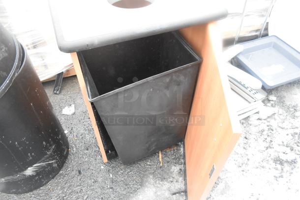 3 brand new scratch and dent trash can shells, including 2 black poly and 1 wood pattern.