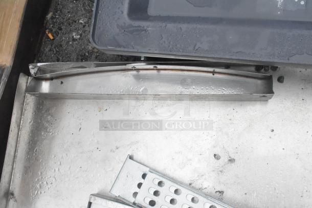 Seven assorted metal items with varying shapes and sizes, showing signs of wear and slight rust, ideal for scrap or repair projects.