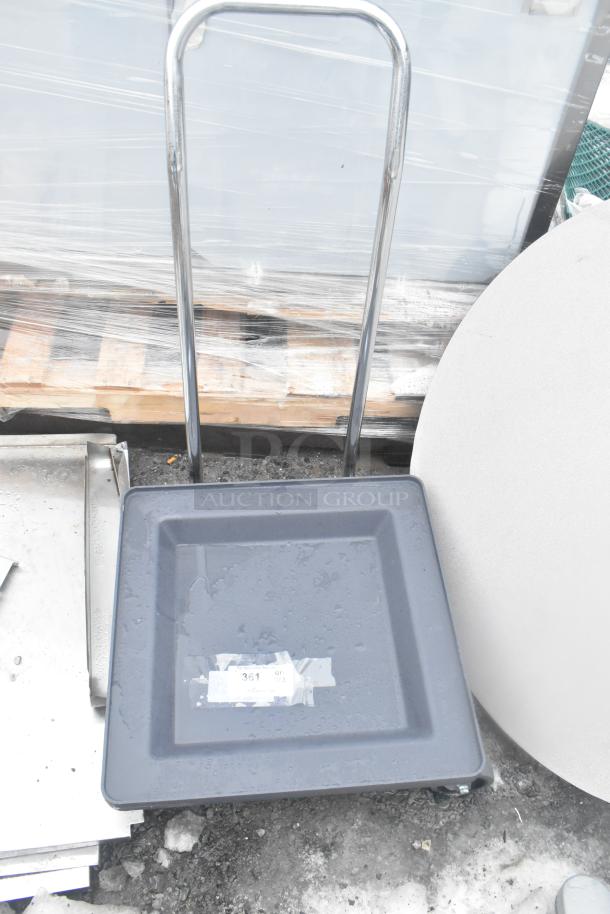 Gray poly dish caddy dolly with handle, on commercial casters. Good condition, visible handle supports easy transport.