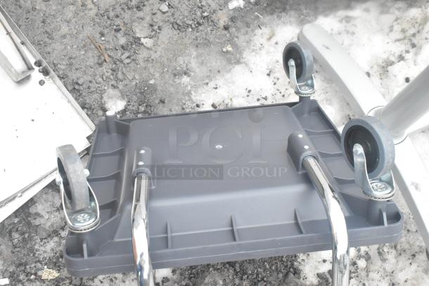 Gray poly dish caddy dolly with handle on commercial casters. Durable design for easy transport.