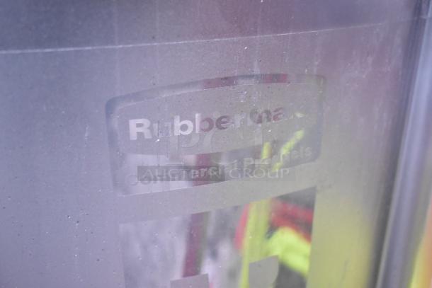 Rubbermaid black poly trash can, commercial grade. Visible label reads "Rubbermaid Commercial Products." Good condition.