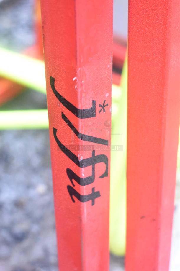 Forza red stool leg with visible text detail, showing modern, durable design. Good condition with minor wear.