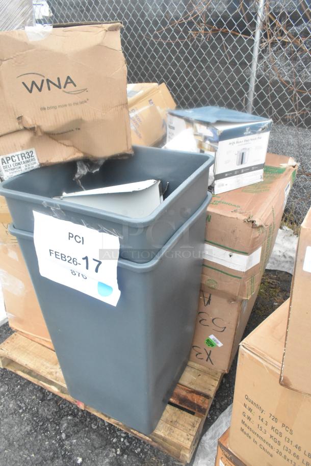 Collection of 13 brand new scratch and dent items, including gray trash cans and assorted boxes, on a wooden pallet.