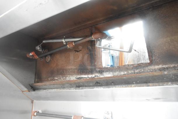 5' commercial grease hood with lights, visible wear and rust, metal construction, interior ventilation system displayed.