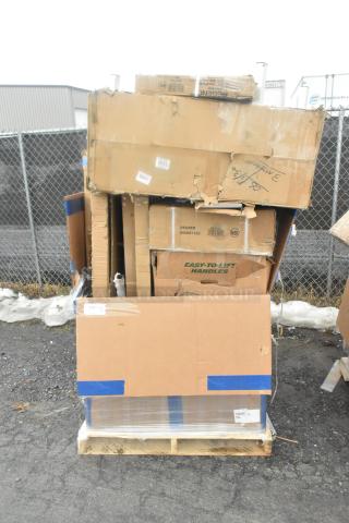 Stack of new, scratch and dent items including work tables and racks in damaged boxes on a pallet.