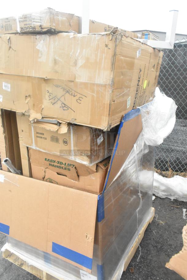 Stack of 12 brand new scratch and dent items in boxes including work tables, shelf, and dunnage rack. Some boxes damaged.