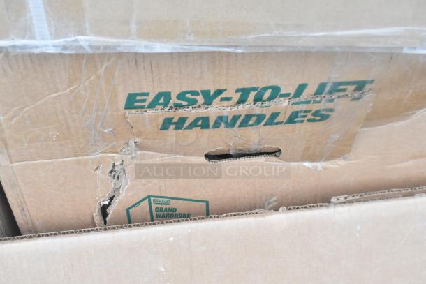 Cardboard boxes labeled "Easy-to-Lift Handles," showing minor scratches. Contains 12 new scratch and dent items: work tables, shelf, dunnage rack.