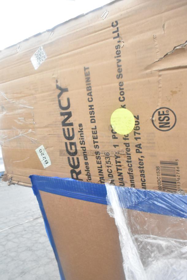 Cardboard box labeled "Regency Stainless Steel Dish Cabinet" showing signs of wear. Includes NSF mark and assorted labels.