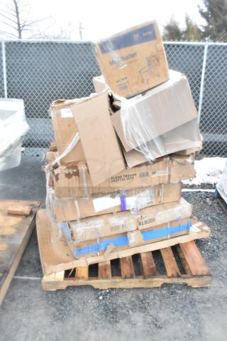 A stack of cardboard boxes on a pallet, labeled with "Floor Trough 600FT24 36SS," showing new scratch and dent items.