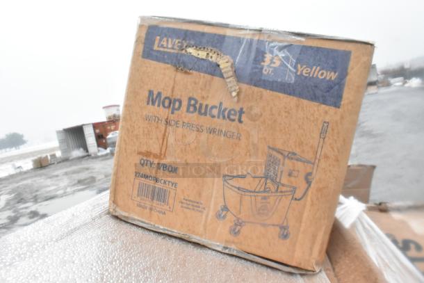 Cardboard box containing a 33 QT yellow mop bucket with side press wringer. Box shows minor damage.